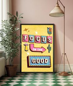 a poster with the words focus on the good in front of a potted plant