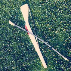 a broken baseball bat laying on the ground in the grass with it's blades missing