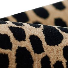 a close up view of a black and brown animal print fabric