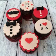 cupcakes decorated with red and white frosting are arranged in a circle