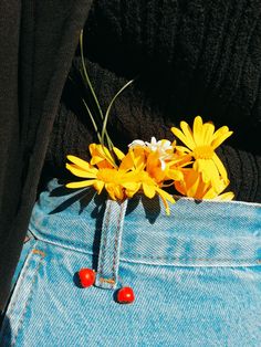 a pair of jeans with flowers in the pocket