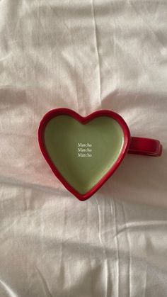 a heart shaped dish on a bed with the words mother and child written on it