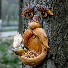 a bird feeder made to look like a man's face with long hair and beard