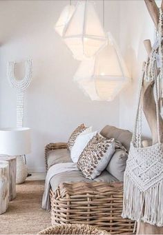 a living room with wicker furniture and chandelier hanging from it's ceiling