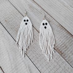 Get in touch with your spooky side with these Ghost Beaded Fringe Earrings! These unique earrings feature delicate beading in a cascading fringe design. Perfect for adding a touch of whimsy to your outfit, these earrings are lightweight and comfortable to wear all day long. Whether you're dressing up for Halloween or just love all things ghostly, these earrings are sure to make a statement.  Handmade with care, these Ghost Beaded Fringe Earrings are a must-have accessory for any ghost enthusiast Edgy Jewelry, Ghost Earrings, Halloween Earrings, Beaded Fringe, Fringe Earrings, Elegant Earrings, Jewelry Lover, Unique Earrings, Ghost