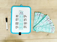 a blue and white board sitting on top of a wooden floor next to lots of money