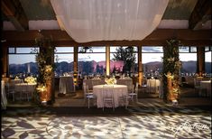 an indoor wedding venue with tables and chairs set up for the guests to sit at