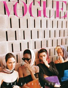 three women sitting on a bench in front of a brick wall with the word vocque