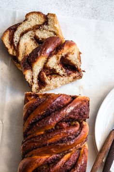 two slices of cinnamon swirl bread sitting on top of a white plate next to a knife and fork