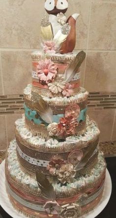 a multi layer cake with an owl on top