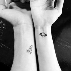 two people with matching tattoos on their arms