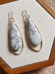 The Voyages collection is inspired by travelling and landscapes. Each piece in this collection features a one-of-a-kind natural semi-precious gemstone, evocative of secret places in the natural world. Large dendritic  jasper drops (5cm) are paired with hand-wrapped 14kt goldfilled teardrop frames. Wirework is 14kt goldfilled while studs are vermeil (gold over silver). Stone measures 46mm x 17 mm x 4 mm. Weighs 7.8g. Each earring is approximately 2.6" long. Secret Places, Hand Wrap, Wire Work, Semi Precious Gemstones, Favorite Jewelry, Jewelry Earrings Dangle, Semi Precious, Singapore, Dangle Drop Earrings