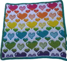 a crocheted afghan with hearts on it