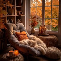 a chair and ottoman in front of a window with fall foliage outside the windowsill