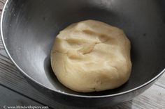 a ball of dough in a metal bowl