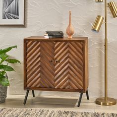 a wooden cabinet sitting next to a lamp on top of a rug