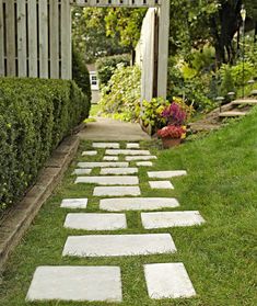 a pathway made out of stepping stones in the grass