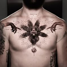 a man with tattoos on his chest and hands around the neck is wearing a crow tattoo