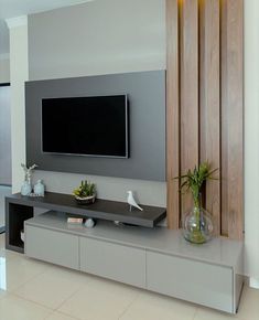 a flat screen tv mounted to the side of a wall in a modern living room