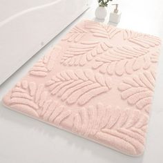 a bathroom rug with leaves on it