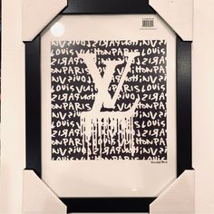 a black and white framed art piece with the letter y on it