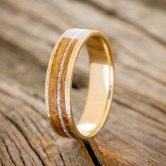 a wooden ring with white and yellow wood inlays