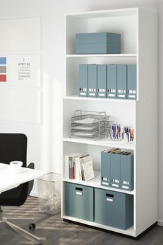 a white bookcase with blue bins and file boxes on it in an office