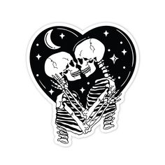 two skeleton stickers in the shape of a heart with stars and moon on it