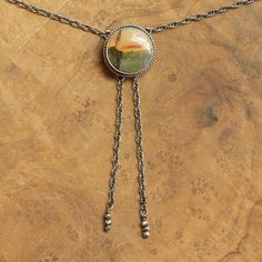 Your choice of stone will be highlighted in the photo as you choose from the drop-down below. This design is a success in so many ways. We love the traditional western bolo tie, but we wanted a more feminine version of it. We've used traditional southwestern silversmithing using .925 twist wire accents - oxidized, sanded, and polished. This necklace closes in the back with a clasp like any necklace and uses an ultra-comfortable .925 Sterling Silver rope chain - the sterling silver chain "tips" a Artisan Jasper Teardrop Jewelry, Round Jasper Gemstone Jewelry, Adjustable Southwestern Jewelry With Natural Stones, Southwestern Adjustable Teardrop Jewelry, Adjustable Southwestern Teardrop Jewelry, Handmade Jasper Round Pendant Jewelry, Teardrop Jasper Jewelry With Natural Stones, Vintage Jasper Jewelry With Natural Stones, Artisan Jasper Jewelry In Oval Shape