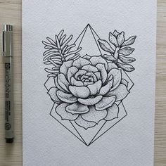 a drawing of a flower on paper next to a pen and ink roller with an ink marker