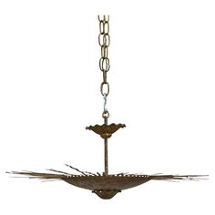 an old chandelier hanging from a chain with two birds on the front and bottom