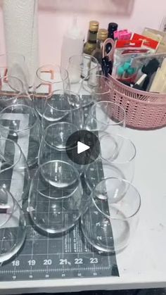 a table topped with lots of empty wine glasses on top of a white countertop