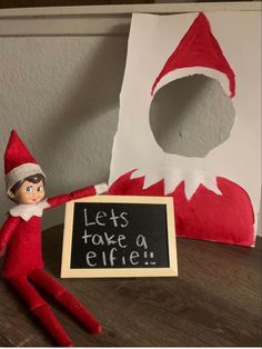 an elf with a sign that says let's take a elfie