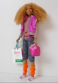 a barbie doll with blonde hair and orange socks holding shopping bags in her hand, against a white wall