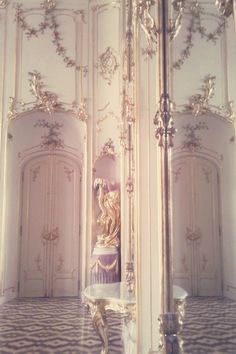 an ornately decorated room with white walls and gold trim