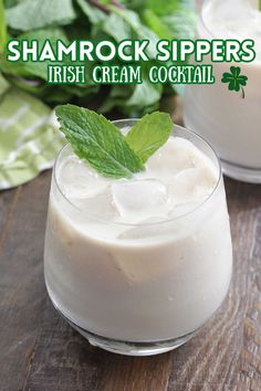 two glasses filled with ice cream on top of a wooden table next to green leaves