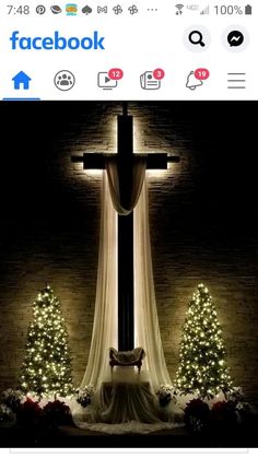 the cross is lit up with christmas lights