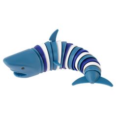 a blue and white plastic toy shark on a white background