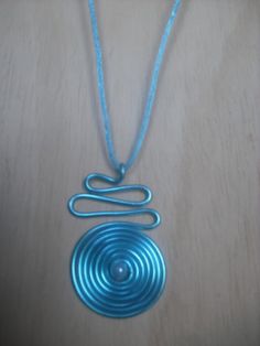 a blue necklace with a spiral design on it