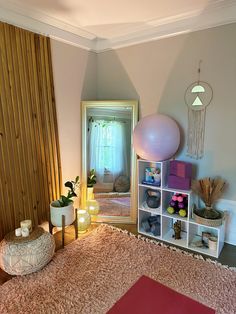 a living room filled with lots of furniture and decor on top of a pink rug