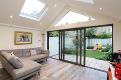 a living room filled with furniture next to a sliding glass door that leads to a backyard