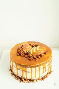 a cake with caramel sauce and nuts on top