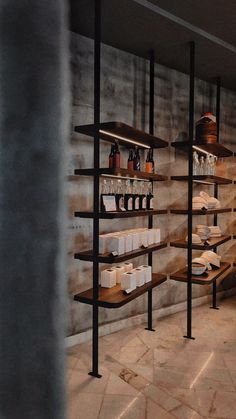 the shelves are filled with bottles and cups