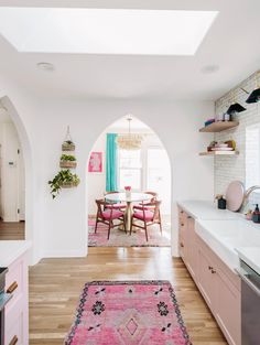 an archway leads to the dining room and kitchen in this modern, open concept home