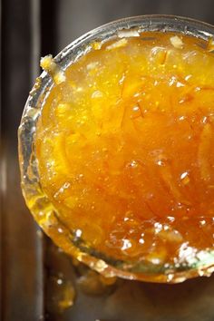 a glass filled with liquid sitting on top of a table