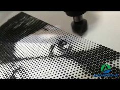 a piece of art made out of small black and white dots on a table top