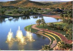 an aerial view of a pond with fountains in it