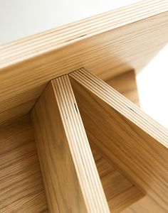 the corner of a wooden table with white background