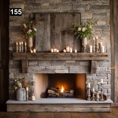 the fireplace is decorated with candles and greenery