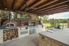 an outdoor kitchen with wood burning ovens